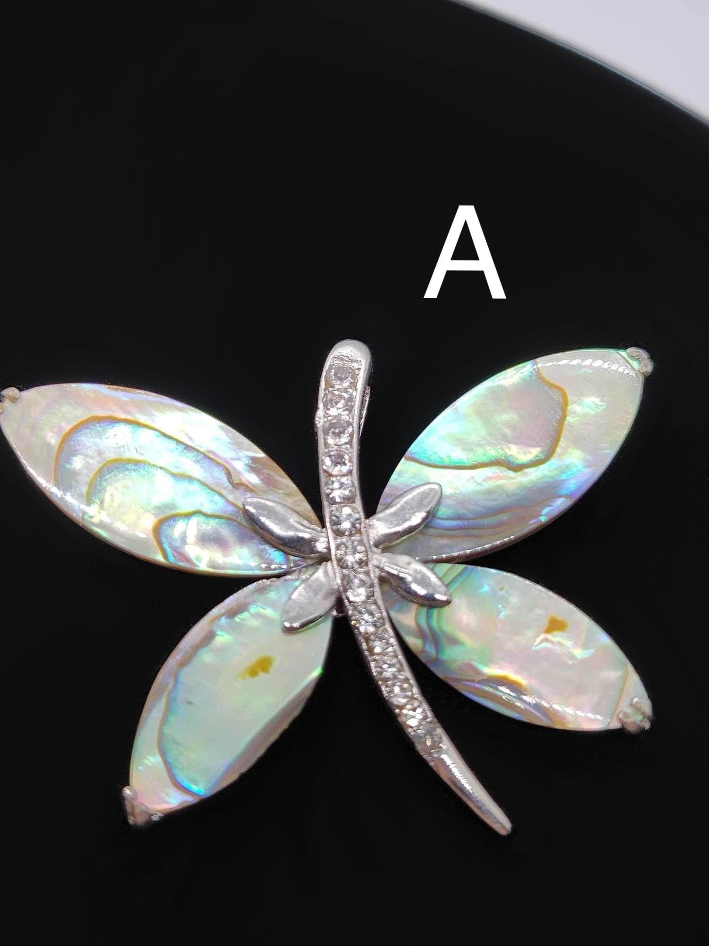 Dragonfly paua shell pendants.