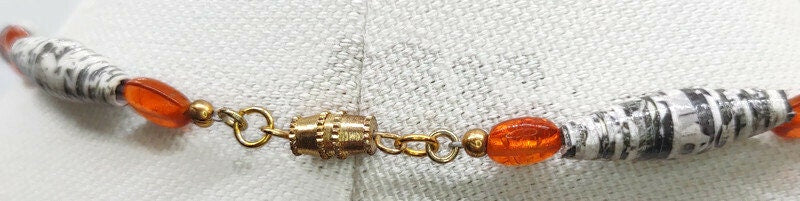Close up of the gold tone alloy metal barrel clasp.