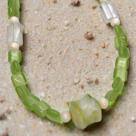Our apple green necklace on sand 