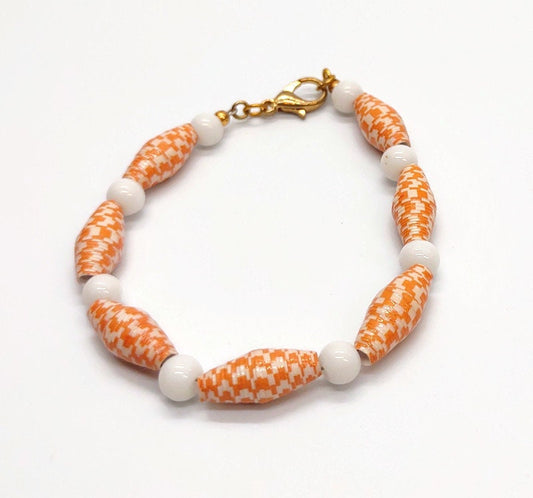 Orange and white paper bead bracelet.