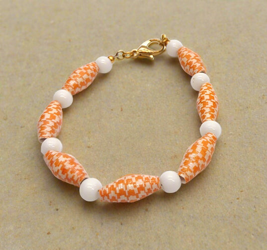 Orange and white paper bead bracelet.